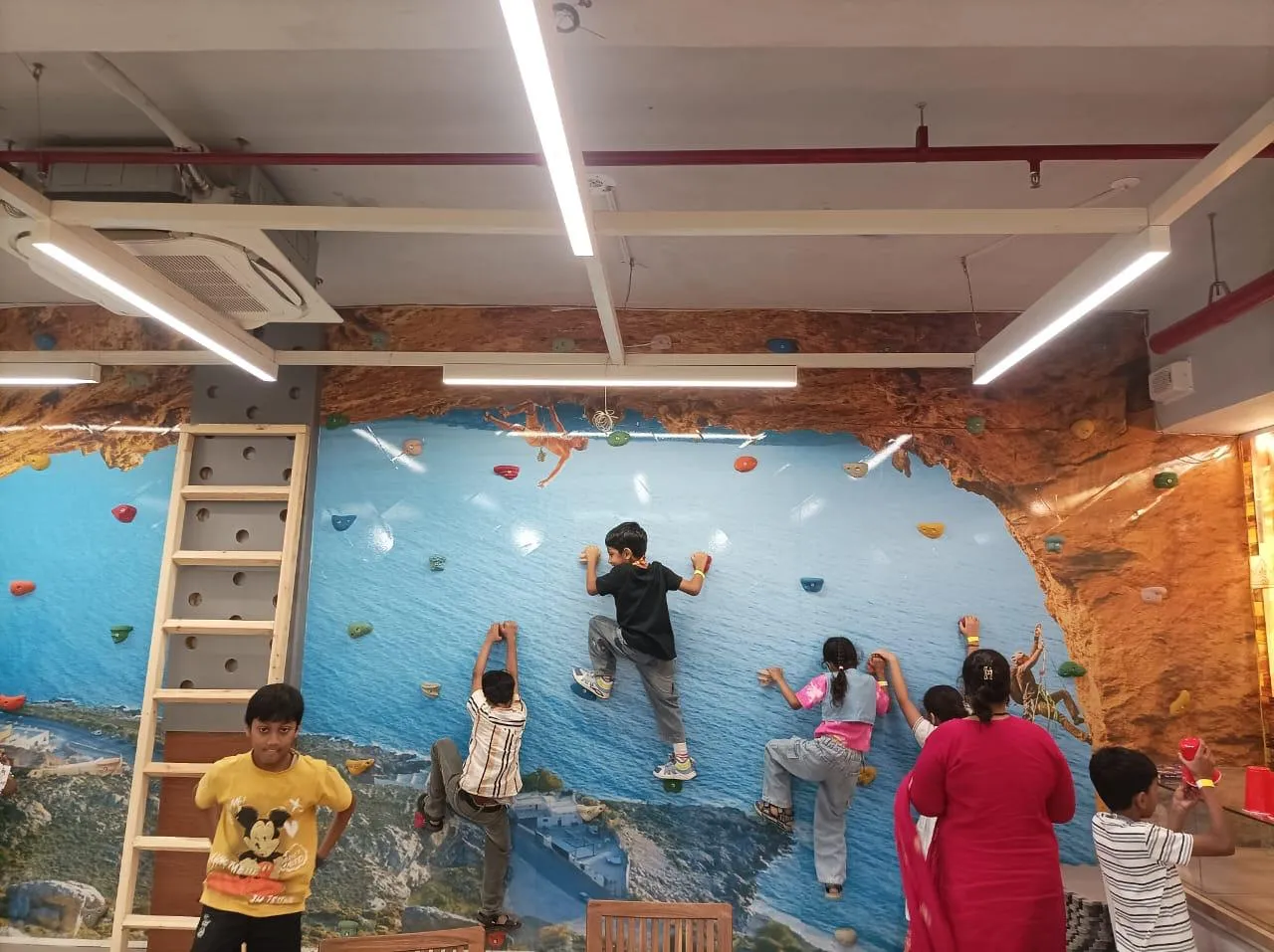 Children enjoying wall climbing activity.